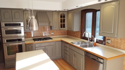 Same kitchen with freshly painted light cabinets