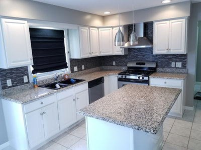 Bright white painted cabinets in a completed kitchen